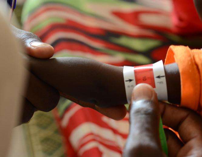 A child is screened for malnutrition in Zamzam camp, Sudan.