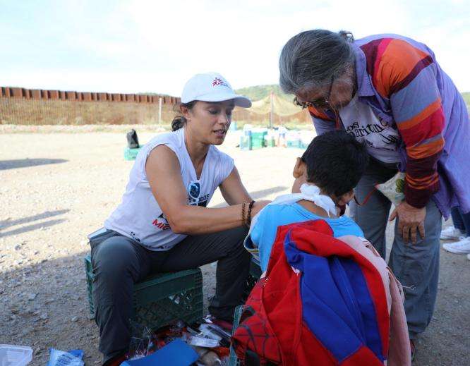 Project Coordinator Belen Ramirez puts a splint on the arm of a 5-year-old boy with a possible fracture in Arizona.