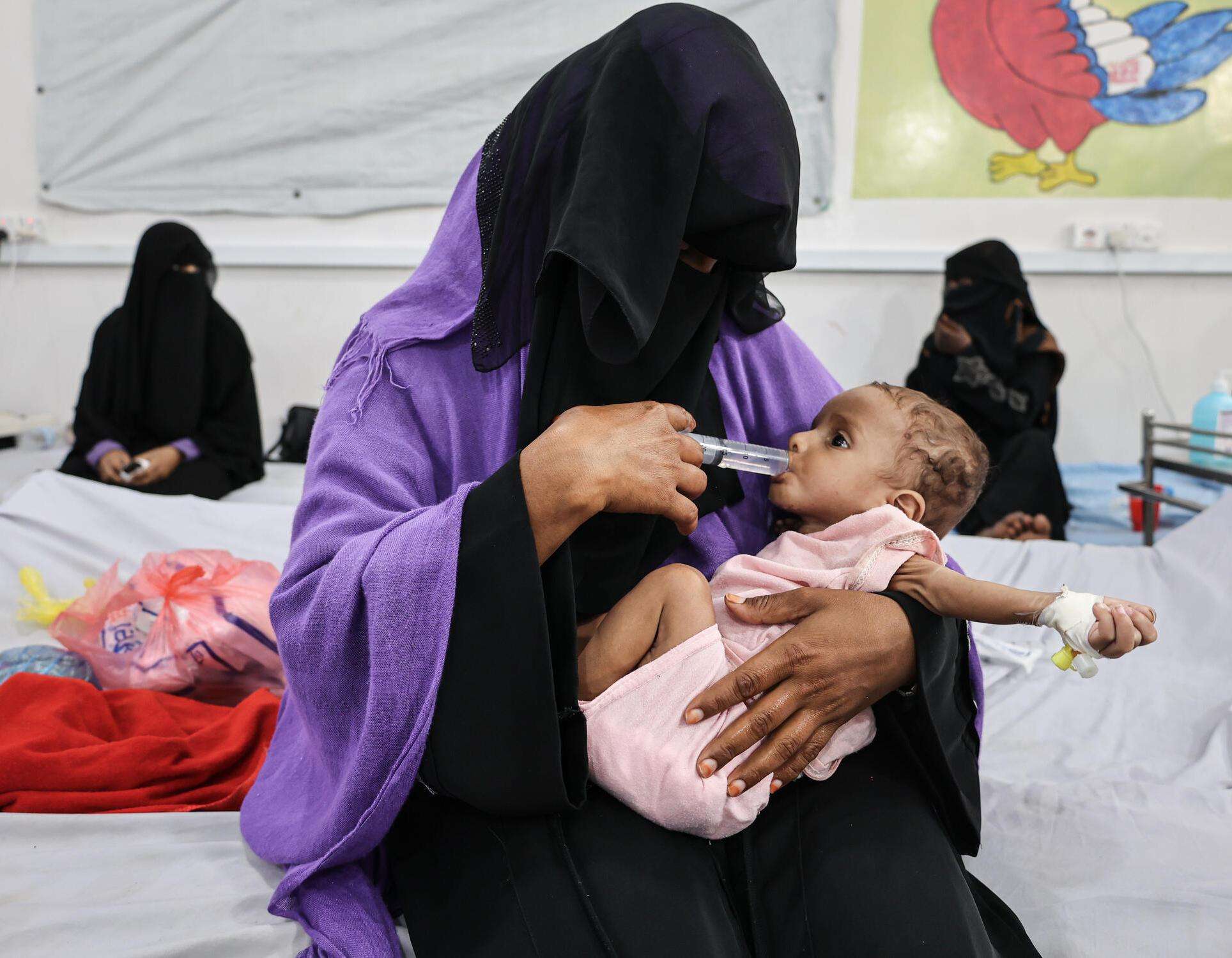 Hajar feeds her nine-month-old son Zaid who was admitted to the MSF-supported inpatient therapeutic feeding center at Abs general hospital, Hajjah governorate, Yemen.