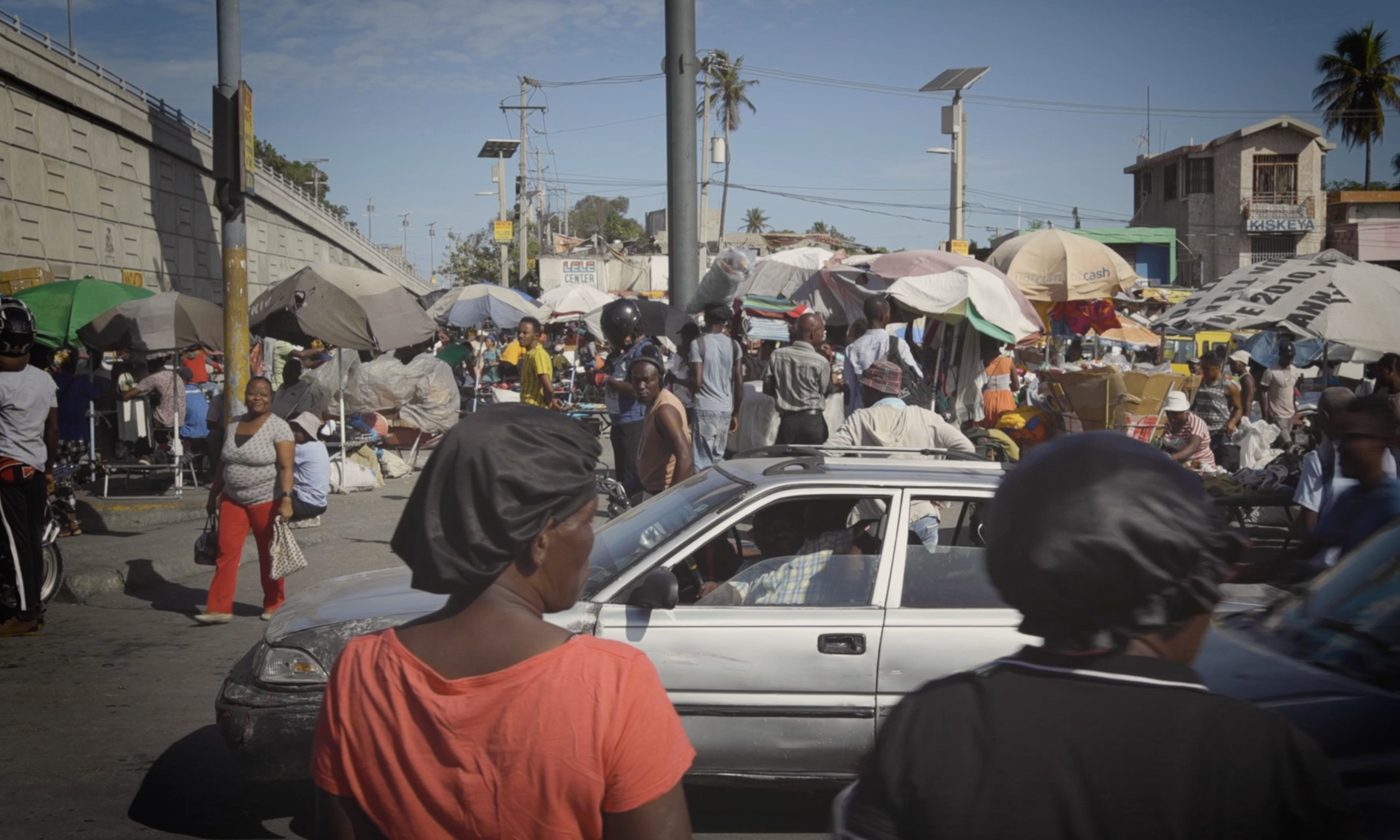 A busy scene with people in the middle of Port-au-Prince