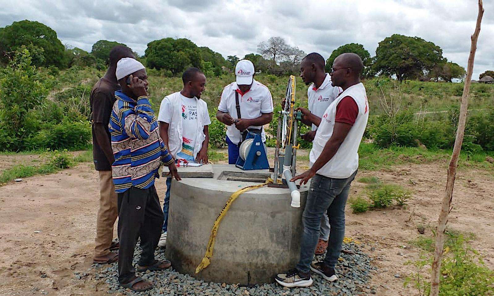 The MSF team checks one of the safeguarded wells equipped with hand pump systems built by MSF to facilitate access to water for communities.