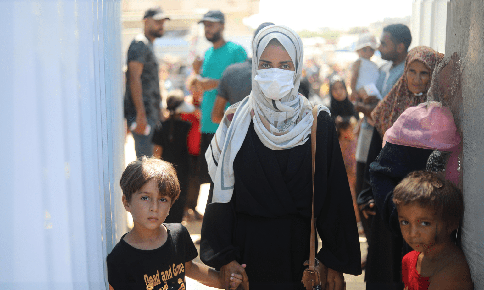 A displaced Palestinian woman and her child in Al-Mawasi, Gaza.