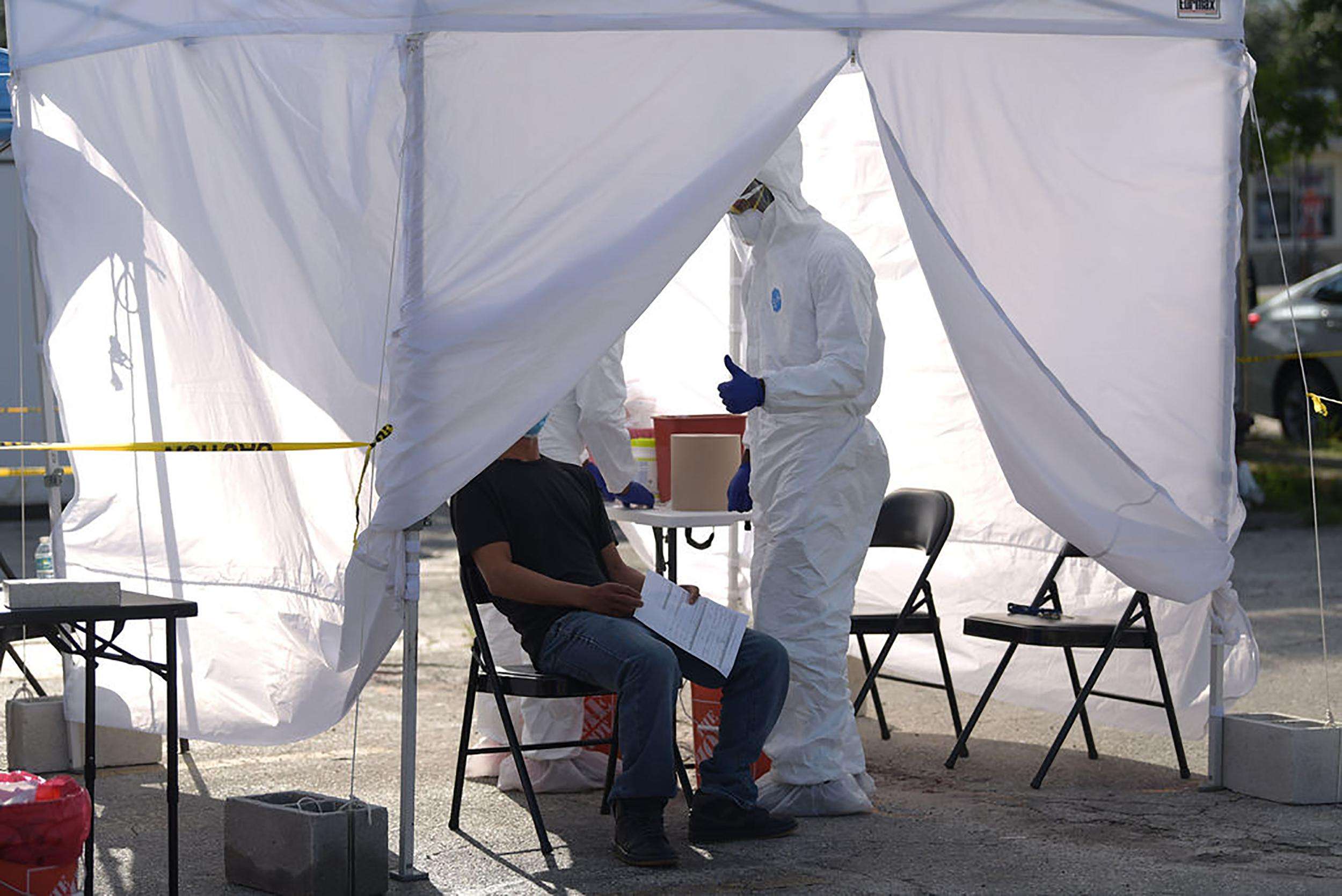 A nurse gives a patient a thumbs-up after completing a free test for COVID-19 at a mobile clinic in Immokalee, Florida.