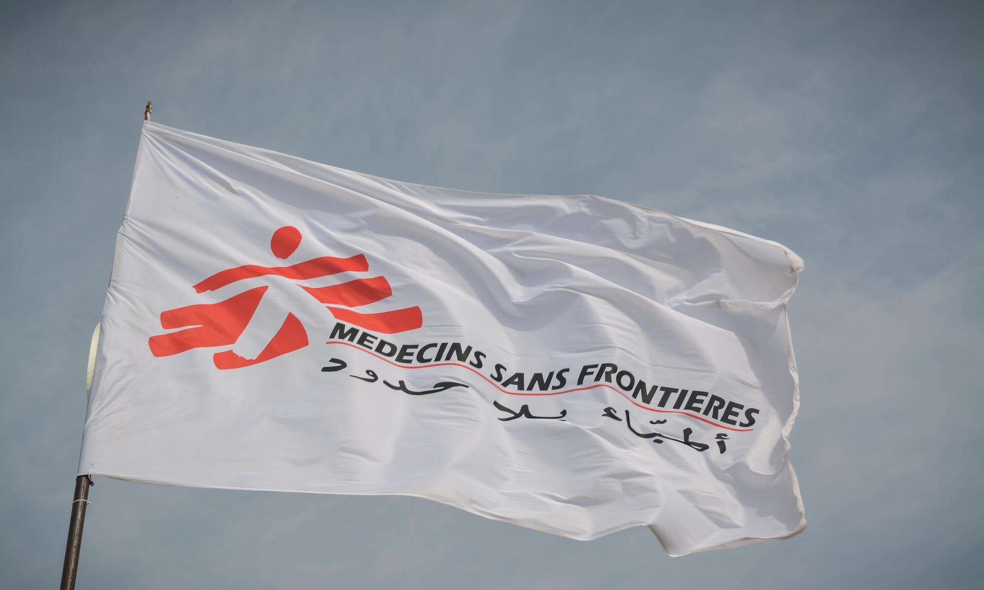 White flag of Doctors Without Borders/Médecins Sans Frontières (MSF) against the sky