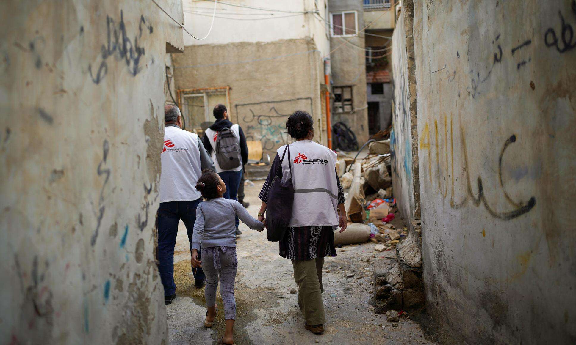 MSF staff walk through an alleyway in Jenin refugee camp, West Bank, Palestine.