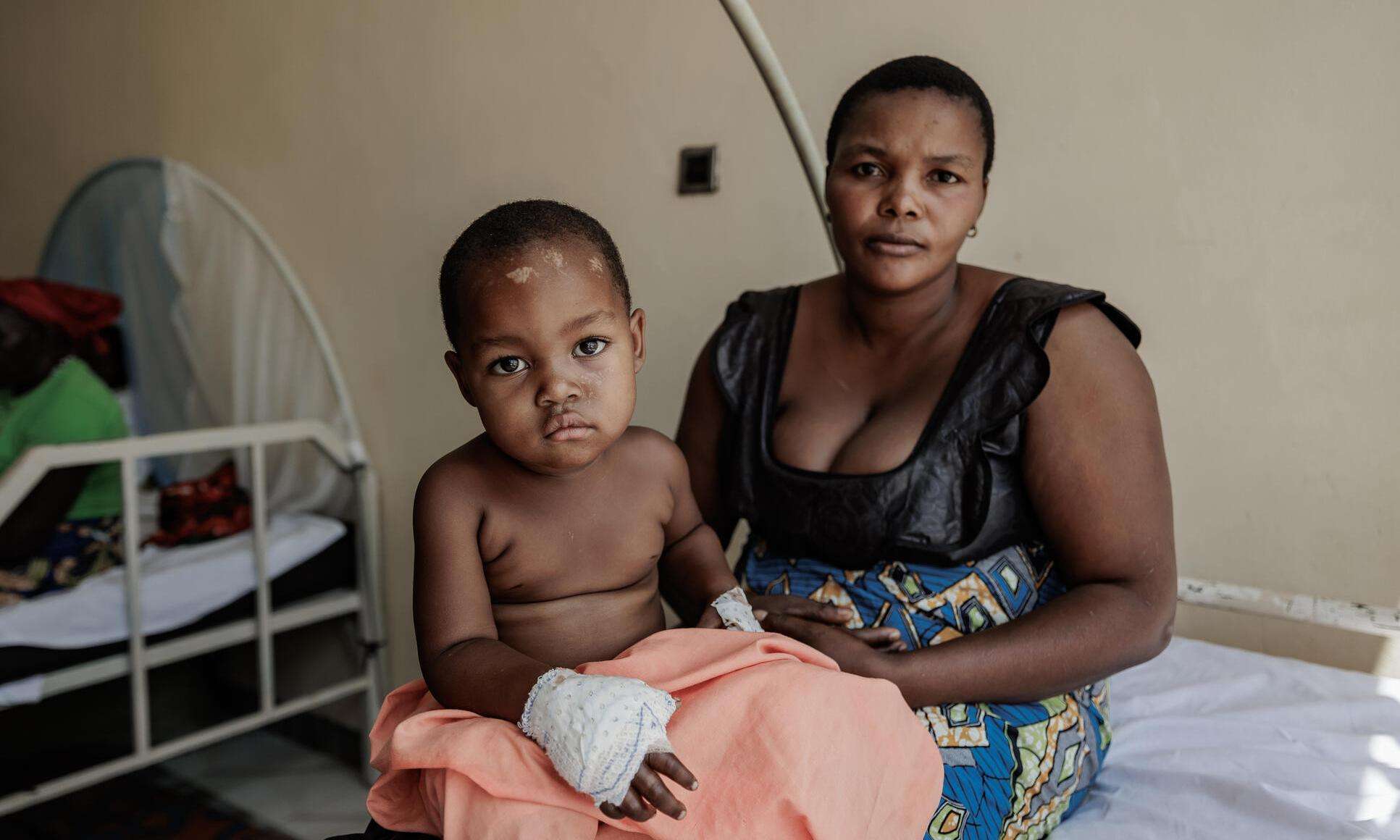 A mother and child sit on a hospital bed at Salama Hospital in Bunia, DR Congo.