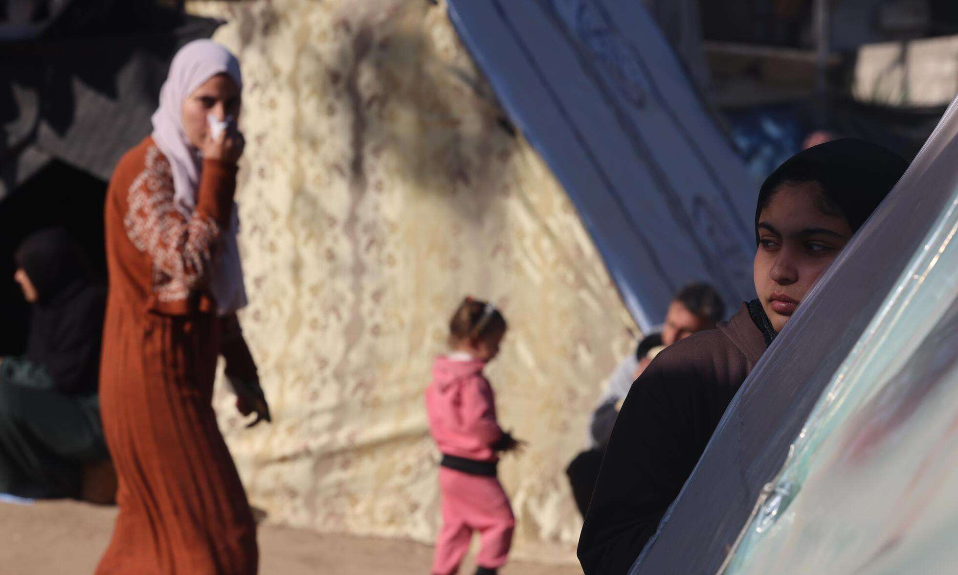 Displaced Palestinian women and children in the southern Gaza town of Rafah’s Al-Shaboura neighborhood.