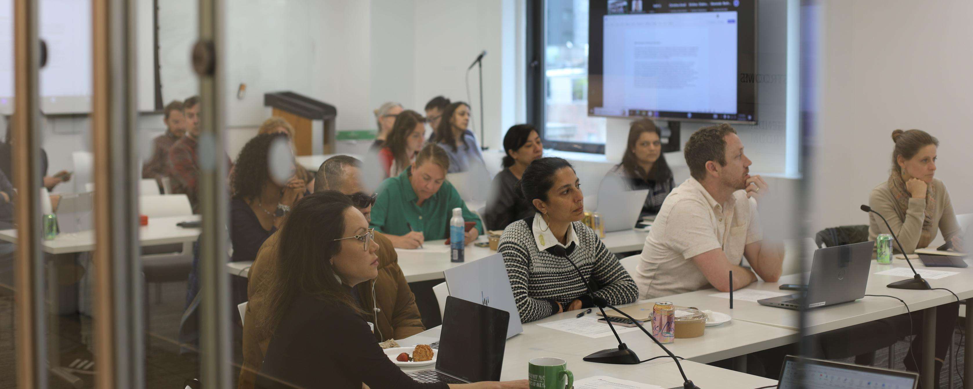 MSF team members sit at tables in a conference room at MSF's US headquarters.