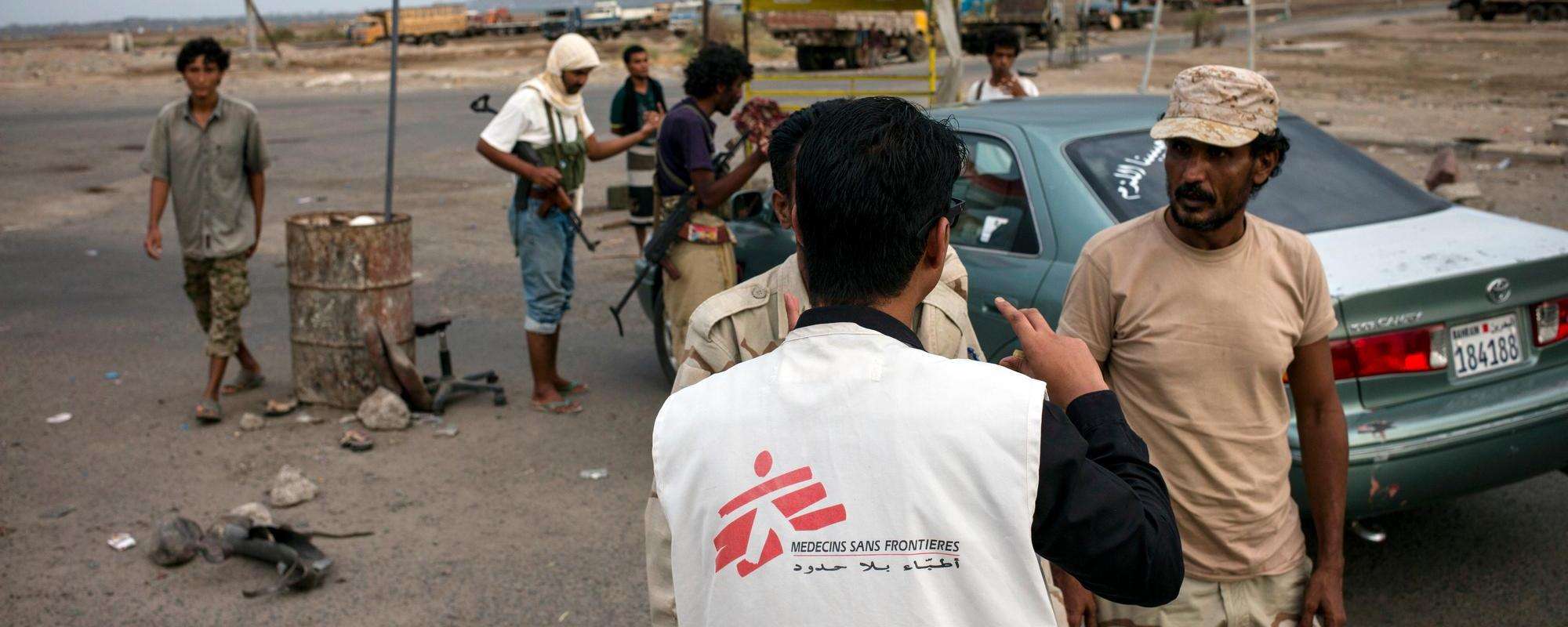 MSF staff speaking with armed men at a check point