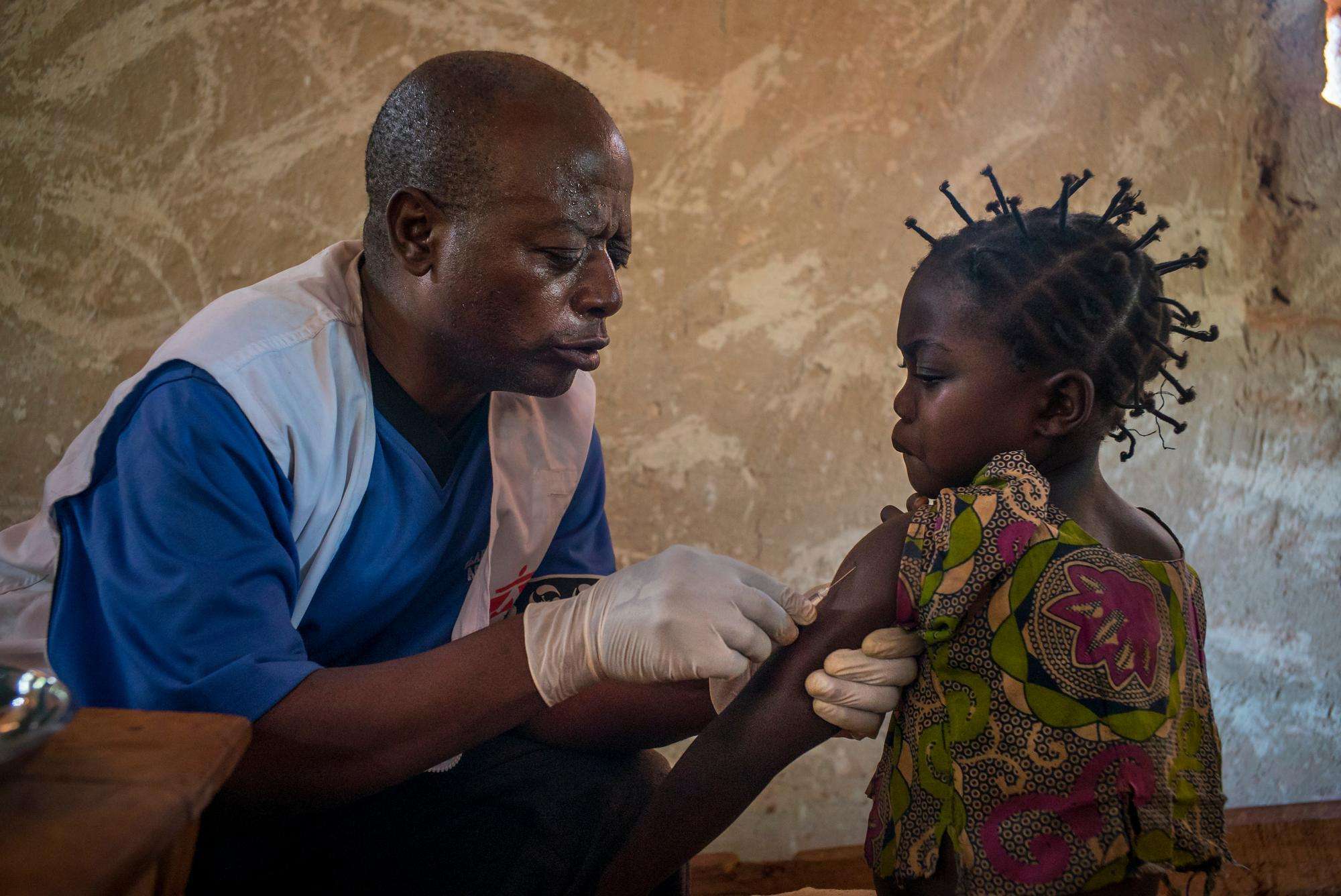 A young girl receives a measles vaccination