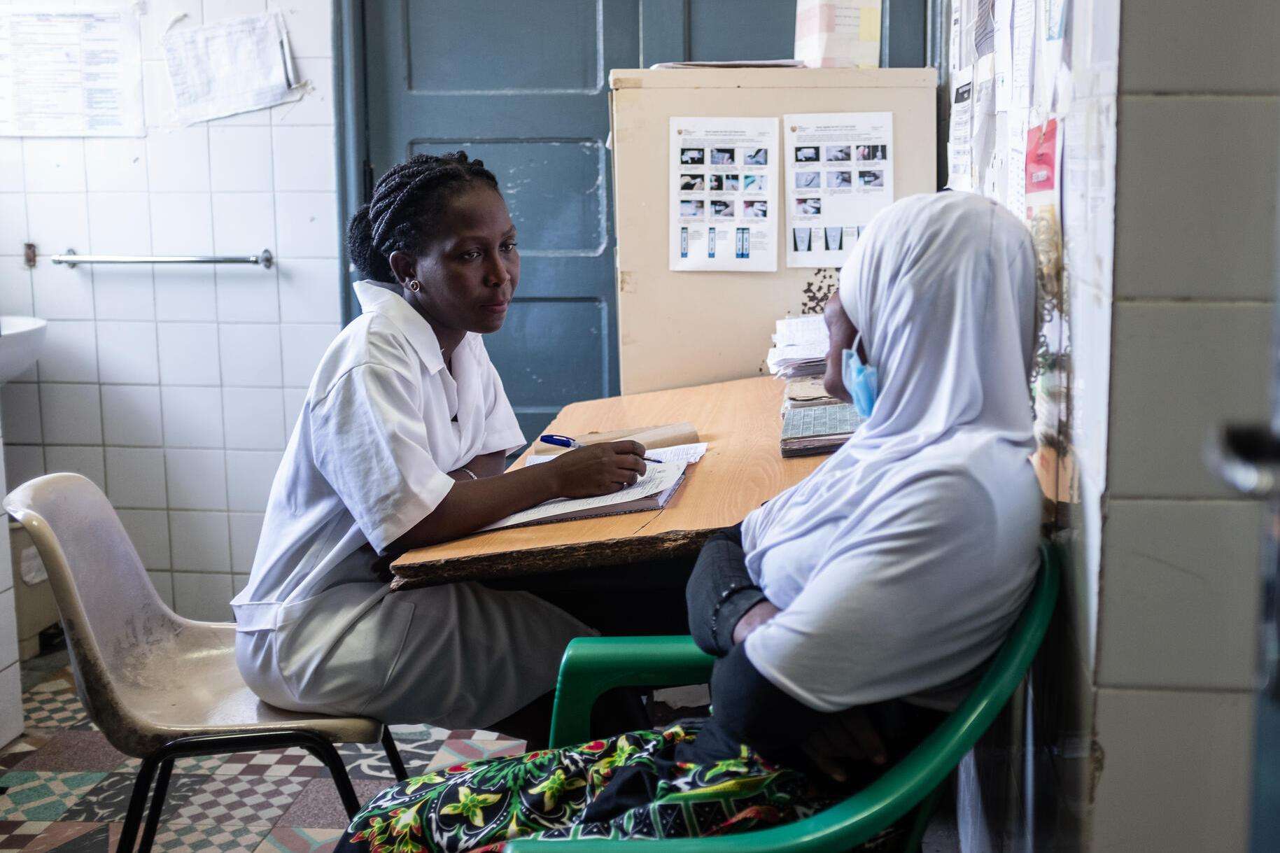 A midwife speaks with a patient at Chingussura health center in Beira, Mozambique.