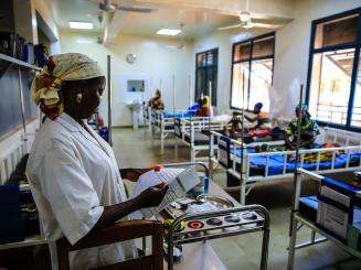  An MSF nurse checks the ﬁle of a child being treated for malnutrition