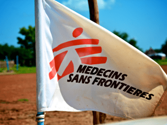 A white flag bearing MSF's logo