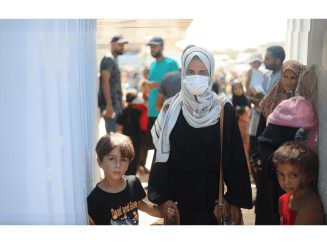 A displaced Palestinian woman and her child in Al-Mawasi, Gaza.