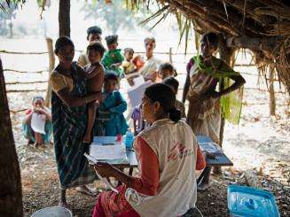 An MSF staff member consulting with patients