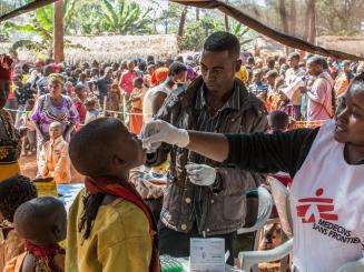 MSF Staff administrate an oral vaccine to a boy at the Nyaragusu refugee camp.