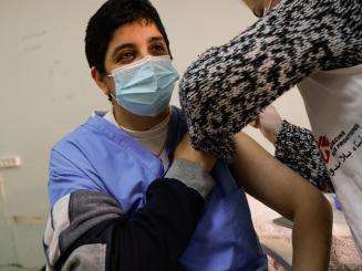 MSF medical mobile team member vaccinates a patient in northern Lebanese city of Tripoli.