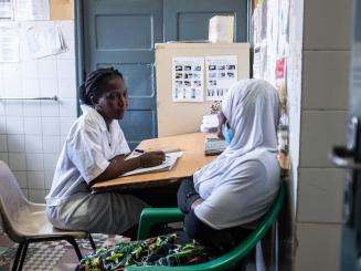 A midwife speaks with a patient at Chingussura health center in Beira, Mozambique.