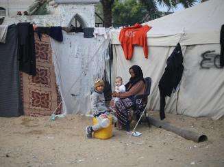 A displaced Palestinian family sheltering in a makeshift camp in southern Gaza. 