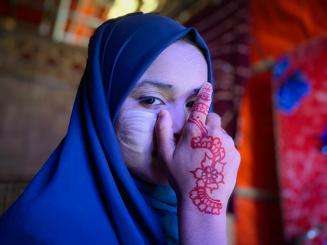 Ayesha, 12, poses with tanaka, a traditional cosmetic, on her face in Cox’s Bazar, Bangladesh.