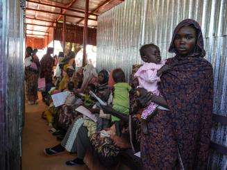 A mother holds her child at MSF's clinic in Zamzam camp in Sudan.