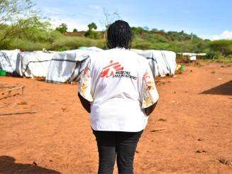 Nancy Mutai, a psychologist, looking at Moinonin camp in Kenya. 