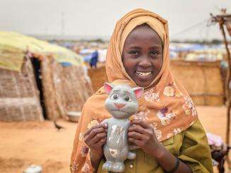 A girl in the Adre camp in Chad holds a cat toy she took with her from Sudan. 