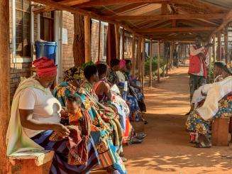 Health promoter, Bayubahe Jerome, educates mothers on the benefits of breastfeeding at Nduta Camp Clinic.