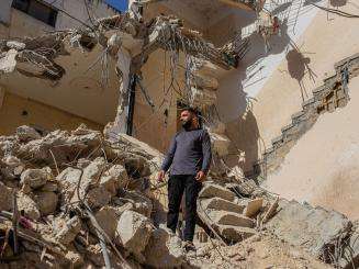 A Palestinian man stands in the rubble of his home after it was bulldozed by Israeli forces in Jenin refugee camp.