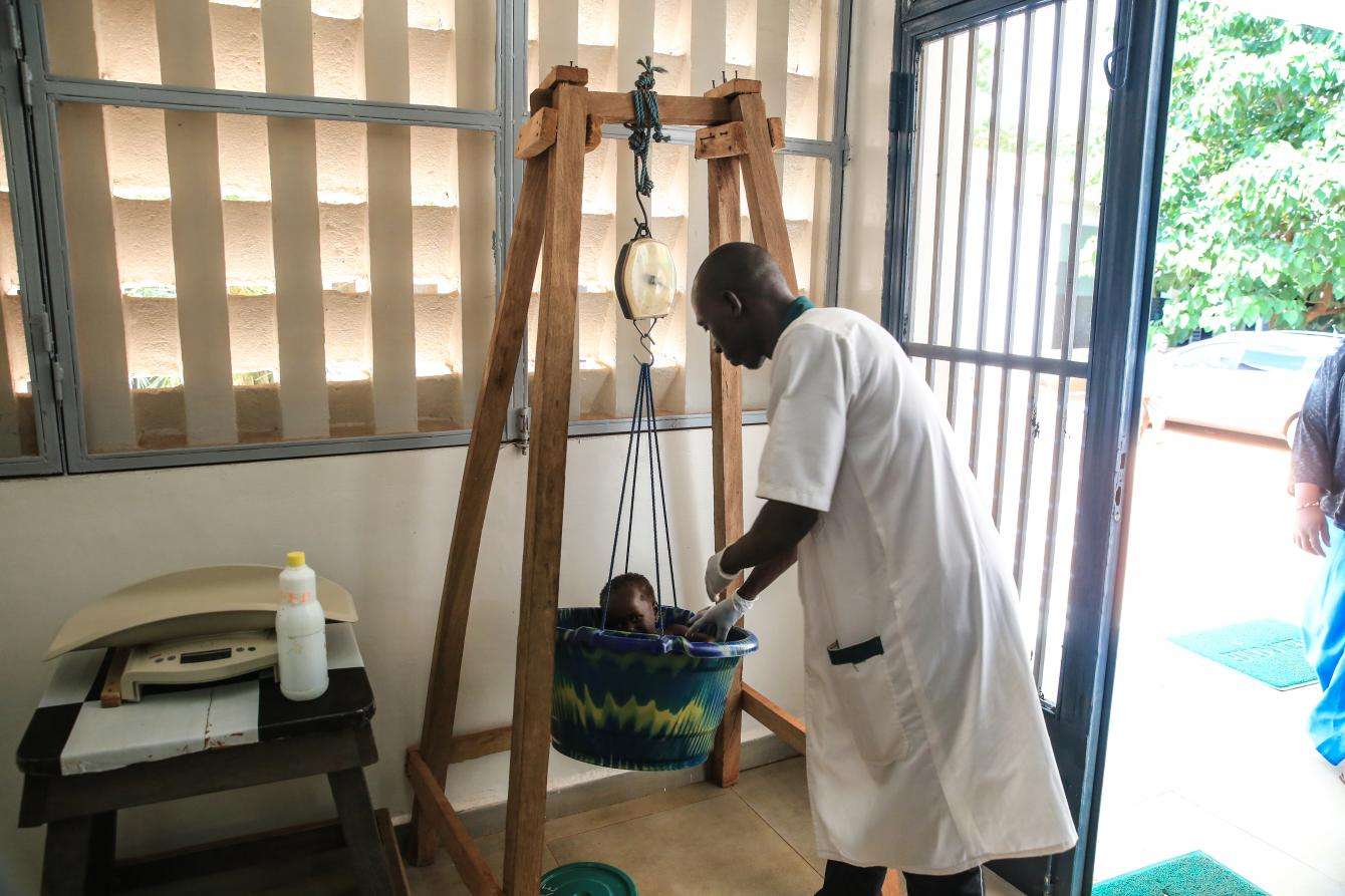 A young child is weighed in Mali 