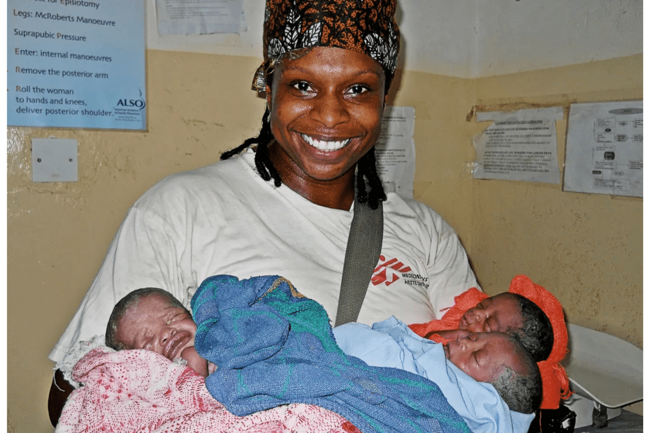 Dr. Africa Stewart holding newborn babies