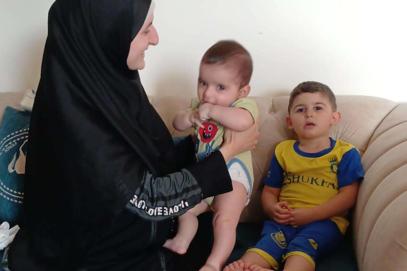 A mother sits with her two sons in south Lebanon. 