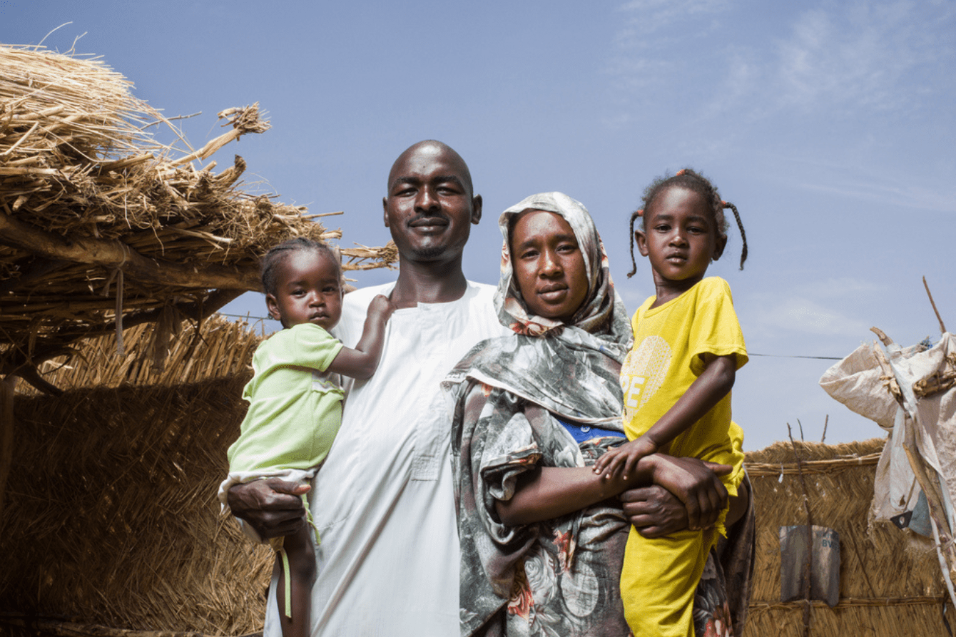 Adam, his wife Nadia, and their children in their shelter in Ambelia camp, Chad.