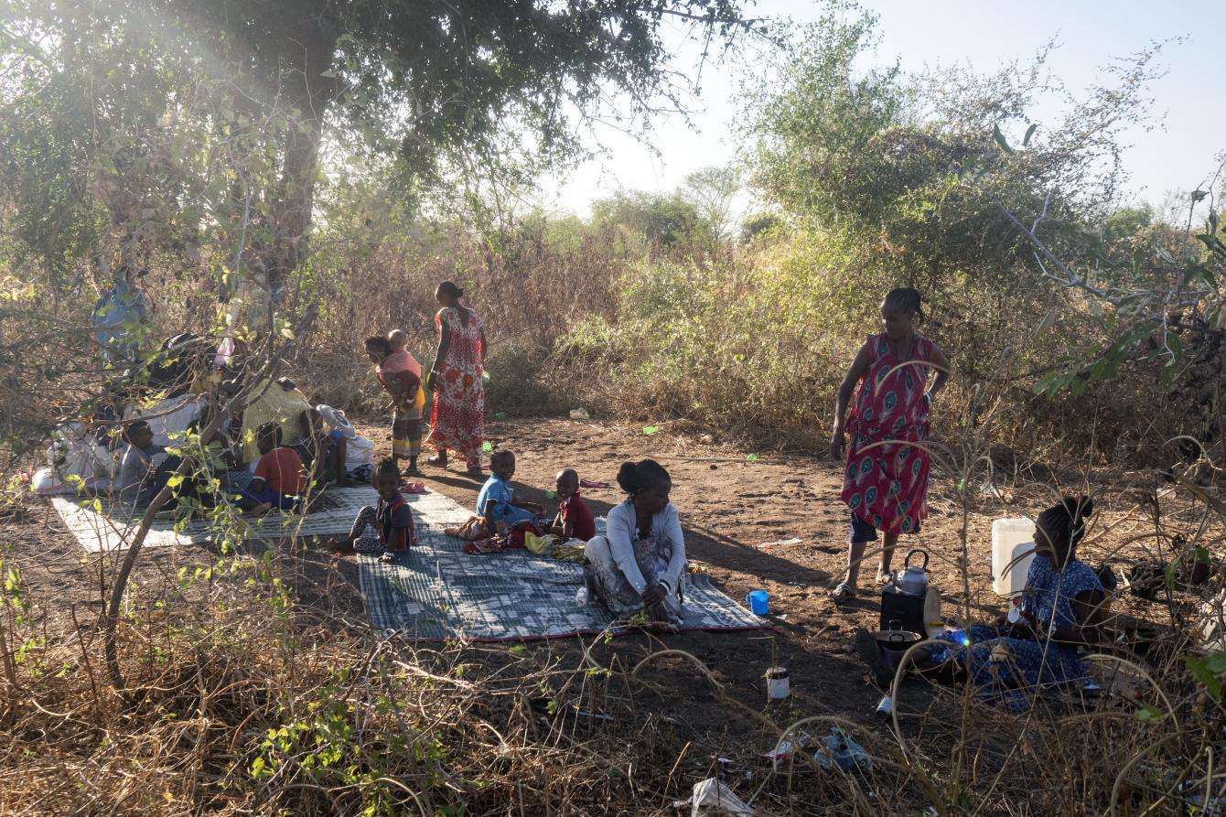 People sitting on blankets outdoors