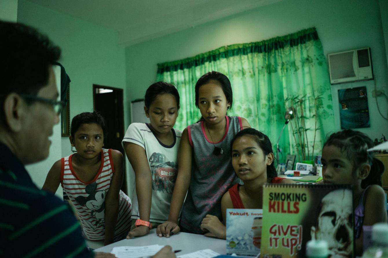 A group of girls come to the Likhaan clinic to receive free HPV vaccinations. 