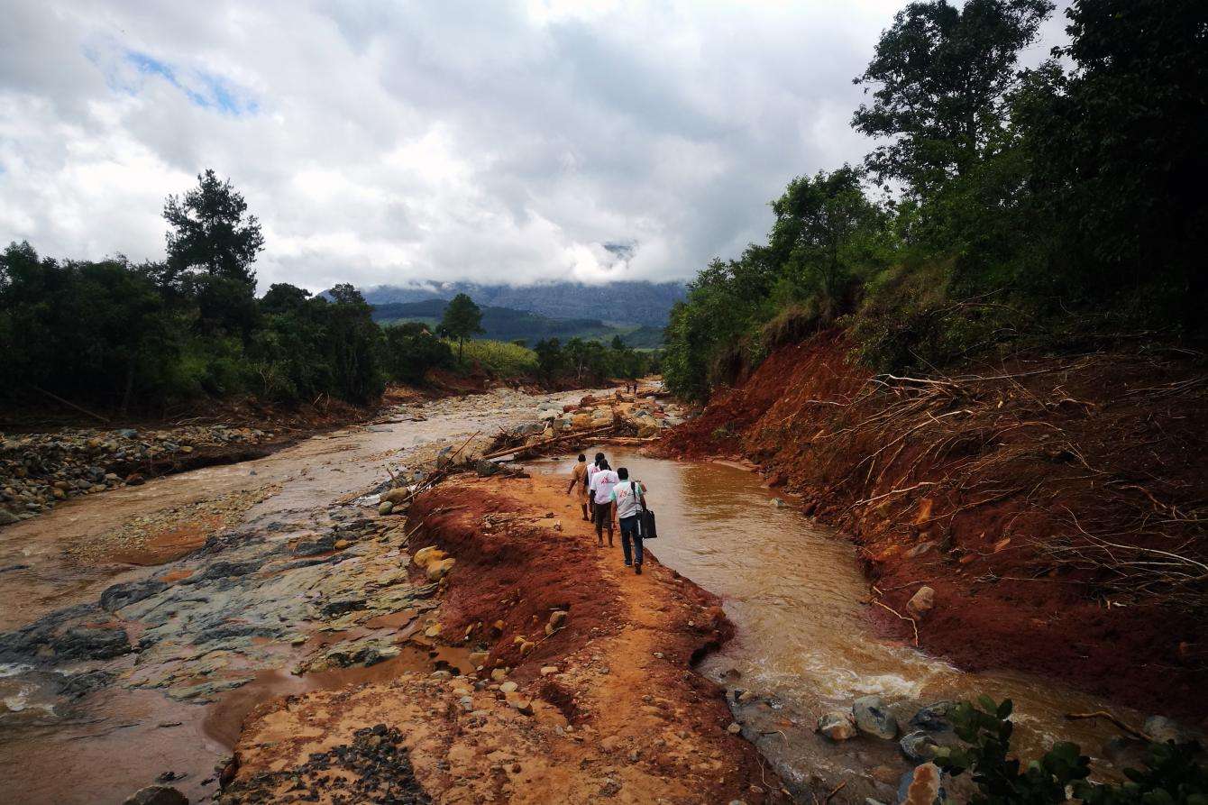 An MSF mobile team walks to access a village cut off by damage caused by Cylone Idai in Chimanimani, Zimbabwe.