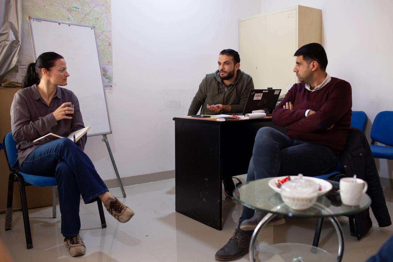 Three people sitting together in an office