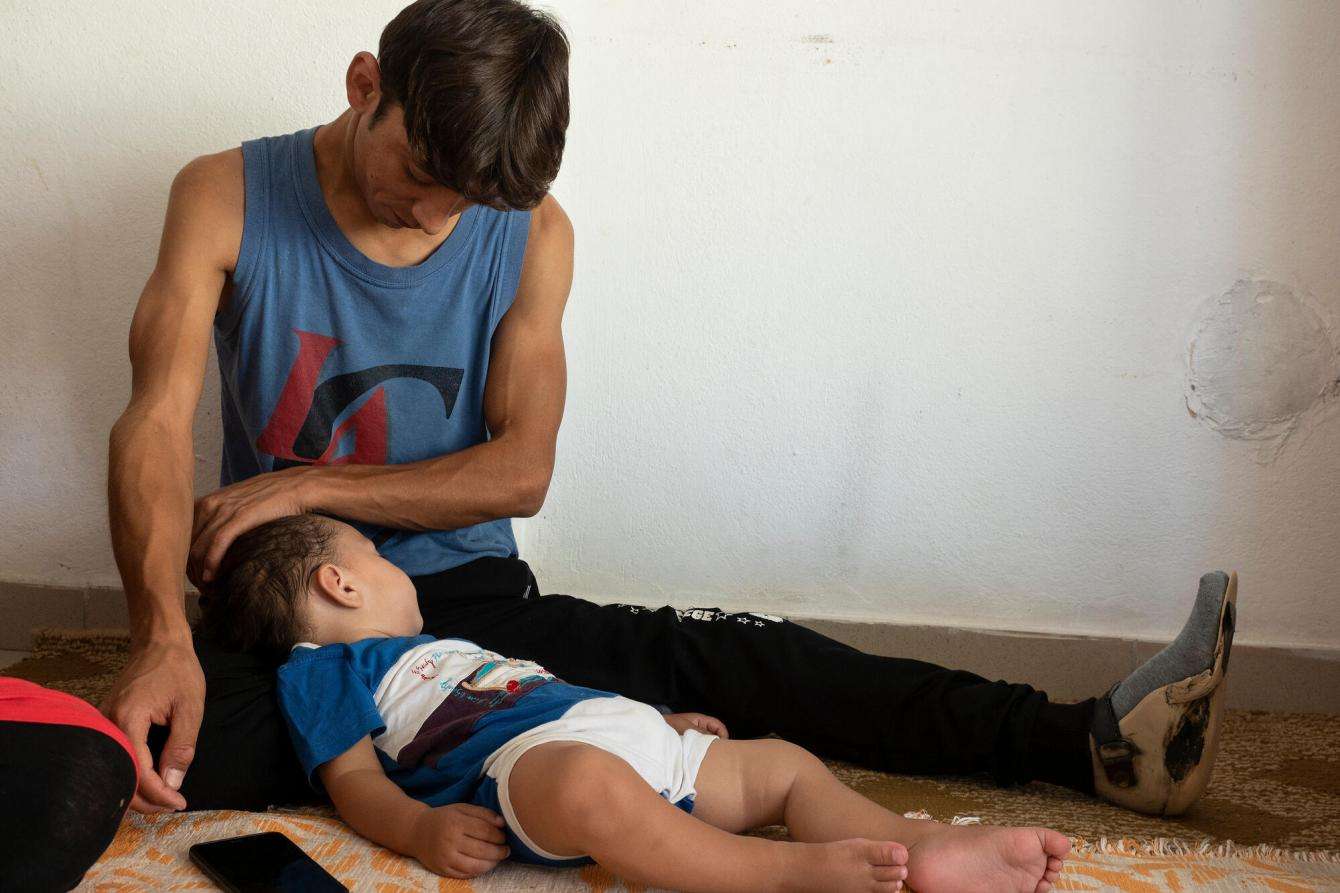 Father and son lay next to each other