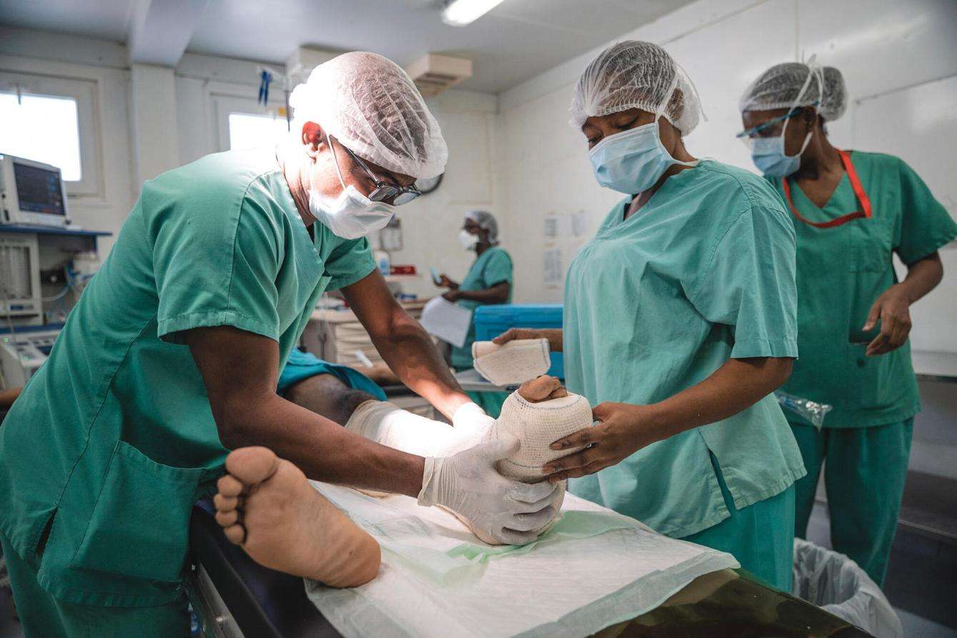 MSF medical staff treat a patient on an operating table at Tabarre hospital in Port-au-Prince, Haiti.