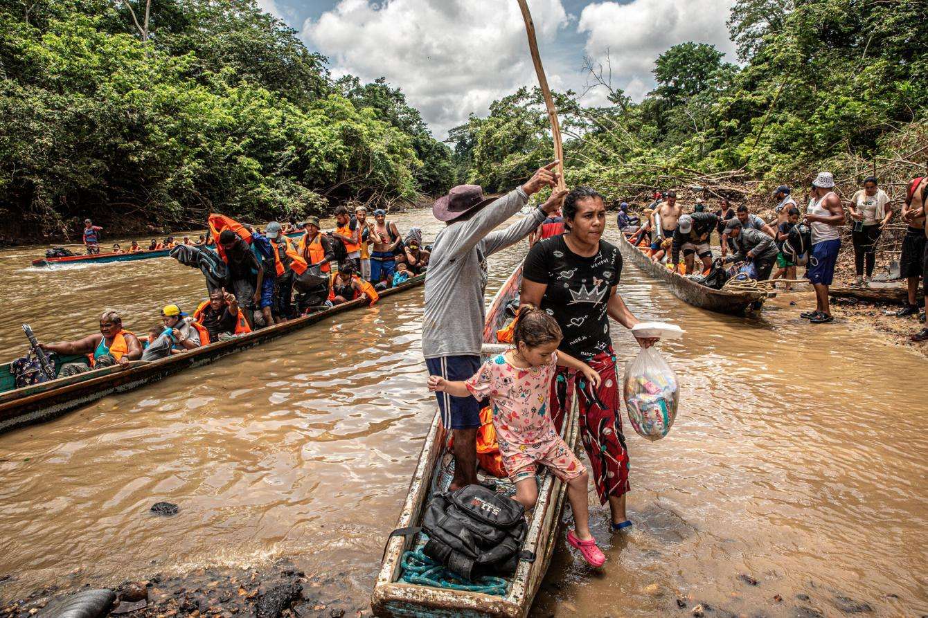 Migrants disembark from canoes in the Darién Gap.