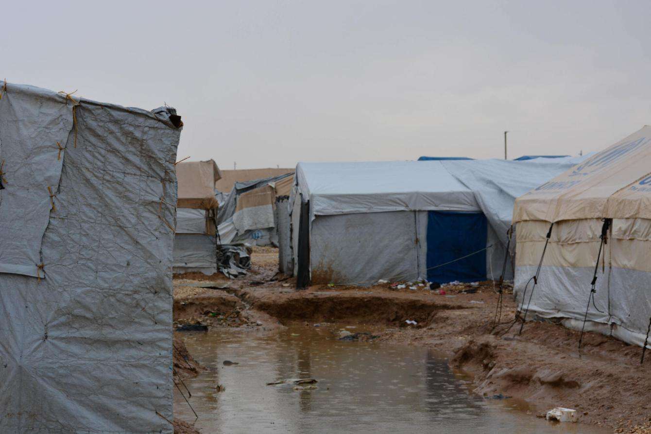 Muddy pools spread across the Al-Hol camp in Northeast Syria after relentless rain. 