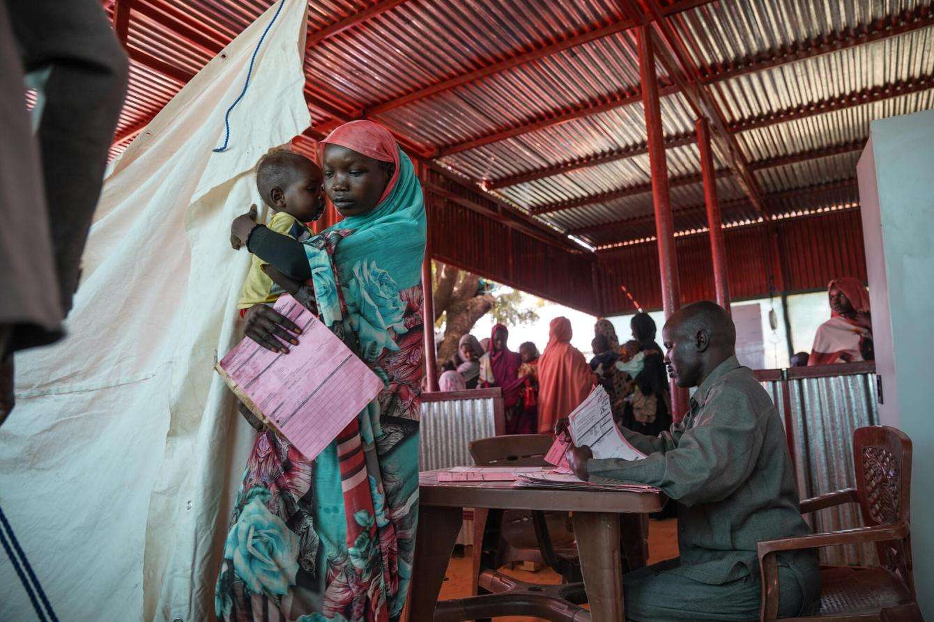 A mother and her child exit the MSF clinic in Zamzam camp, Sudan.