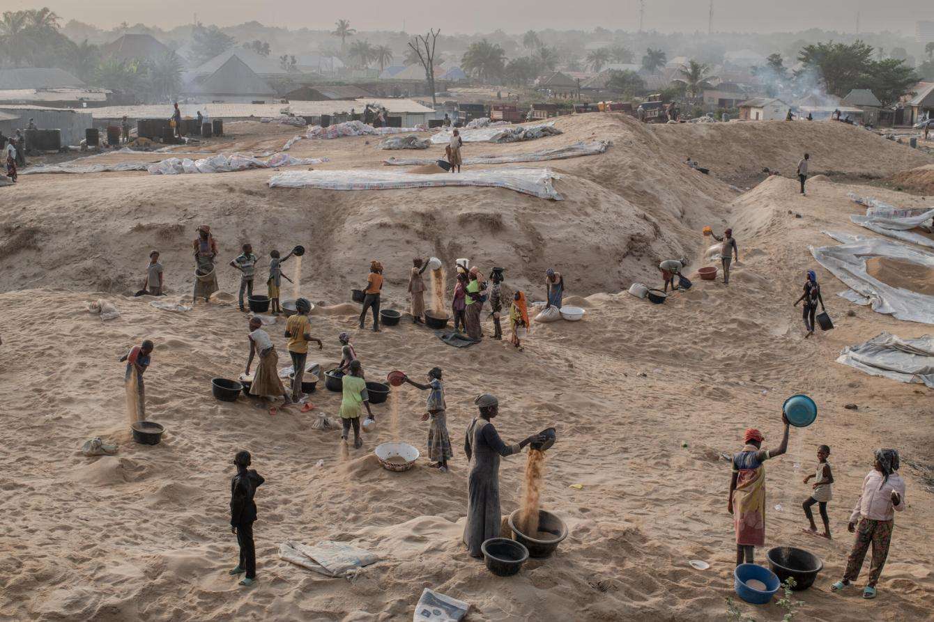 People work in a rice mill located at the entrance to Makurdi town