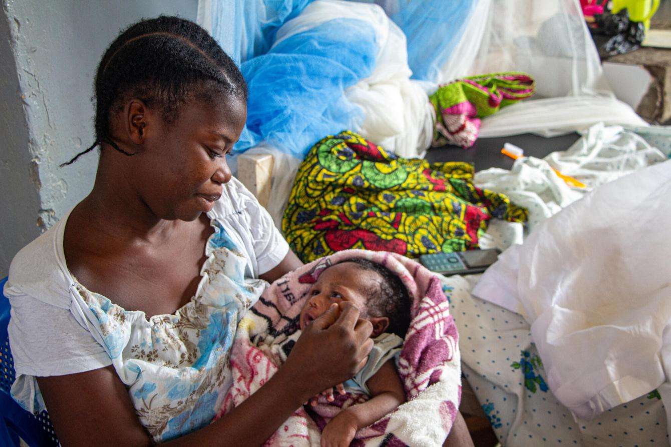 Woman holding a newborn. 