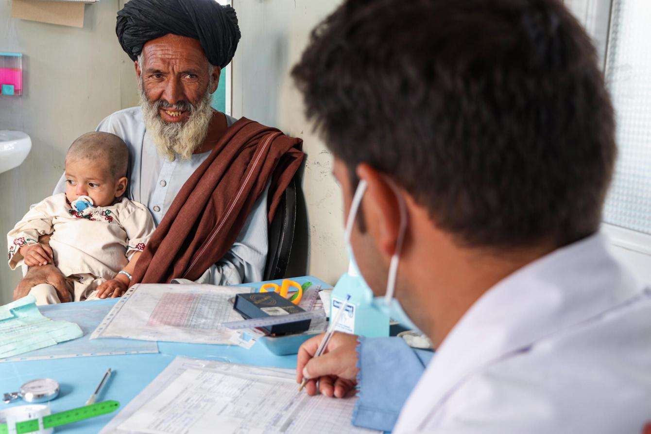 A man brings his grandson for malnutrition treatment in Kandahar, Afghanistan. 