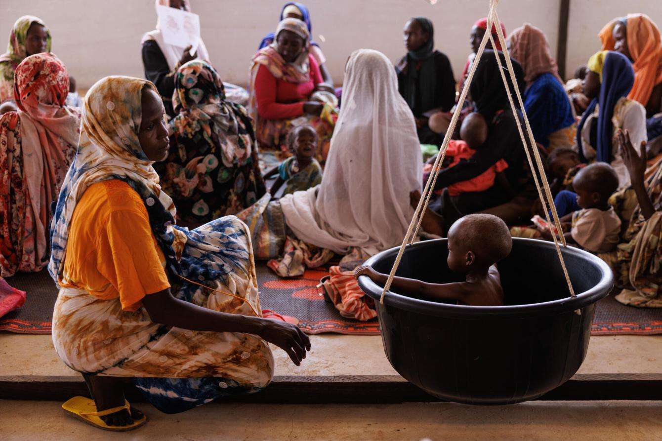 Children arrive with their mothers and are weighed as part of a process that checks for malnutrition inside the Médecins Sans Frontières, (MSF) clinic at a refugee transit camp on April 25, 2024 in Adre, Chad.