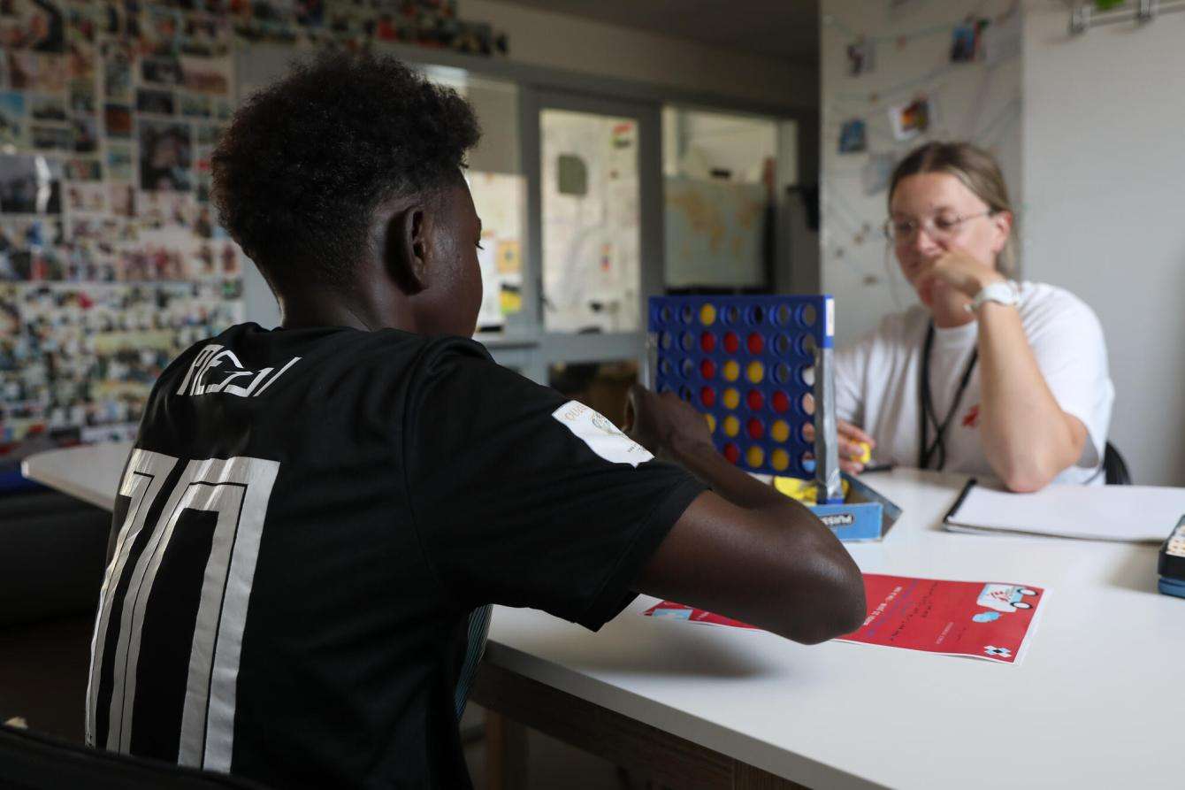 A young man plays a game during a mental health session in Calais.