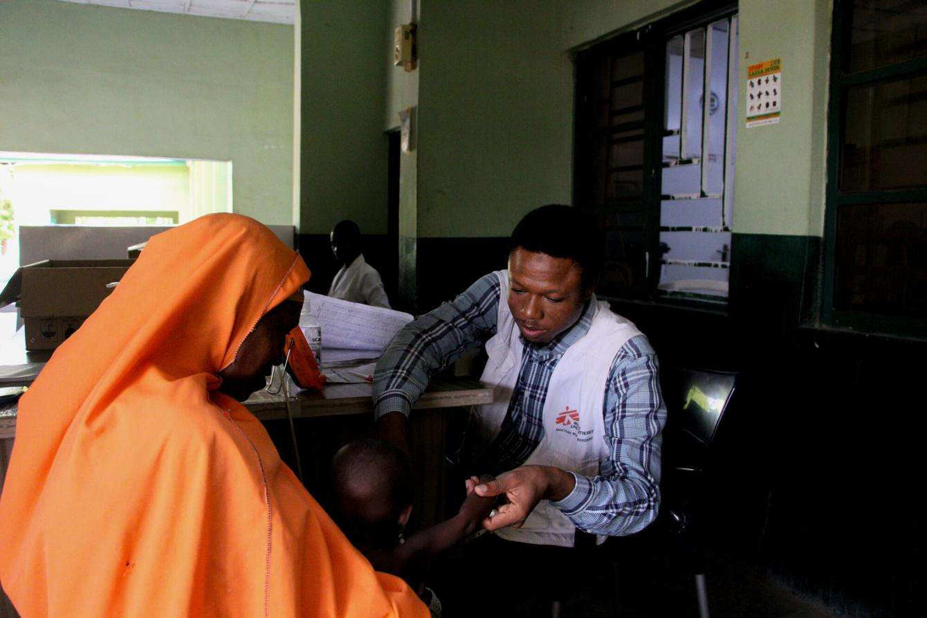 A nurse takes a patient's vital signs in triage in Nigeria. 