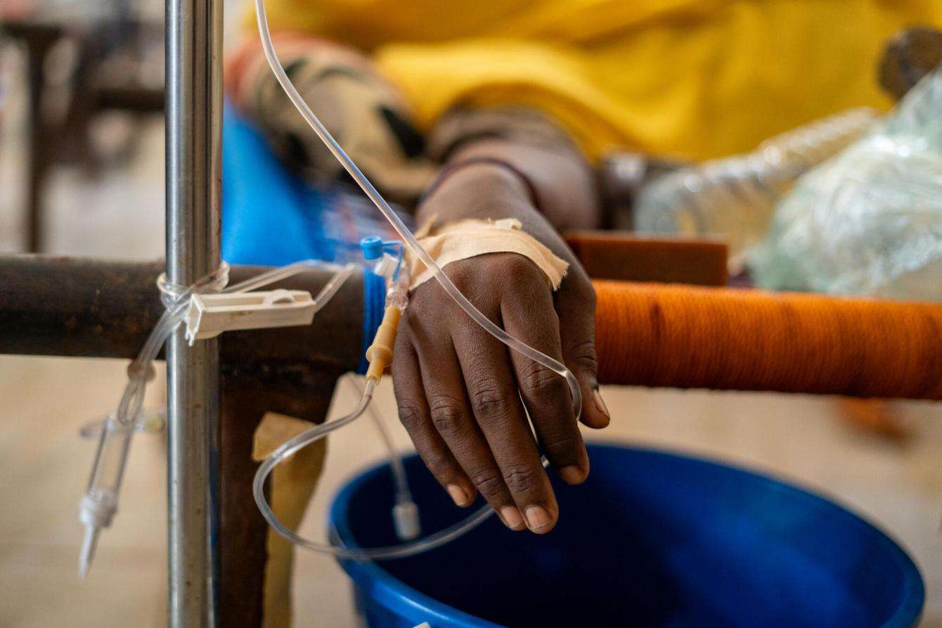 A patient receives IV hydration in a cholera treatment center. 