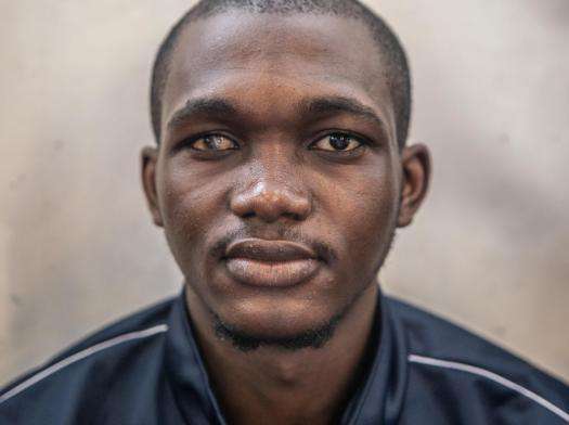 A young man with damaged eye from being tortured in a Libyan prison.